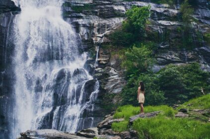 fascinating low angle shot female admiring waterfall doi inthanon park thailand - Magainepanda.com