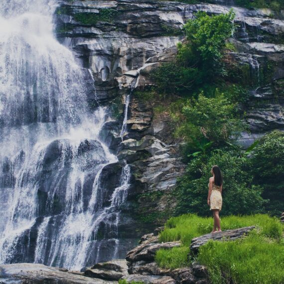 fascinating low angle shot female admiring waterfall doi inthanon park thailand - Magainepanda.com